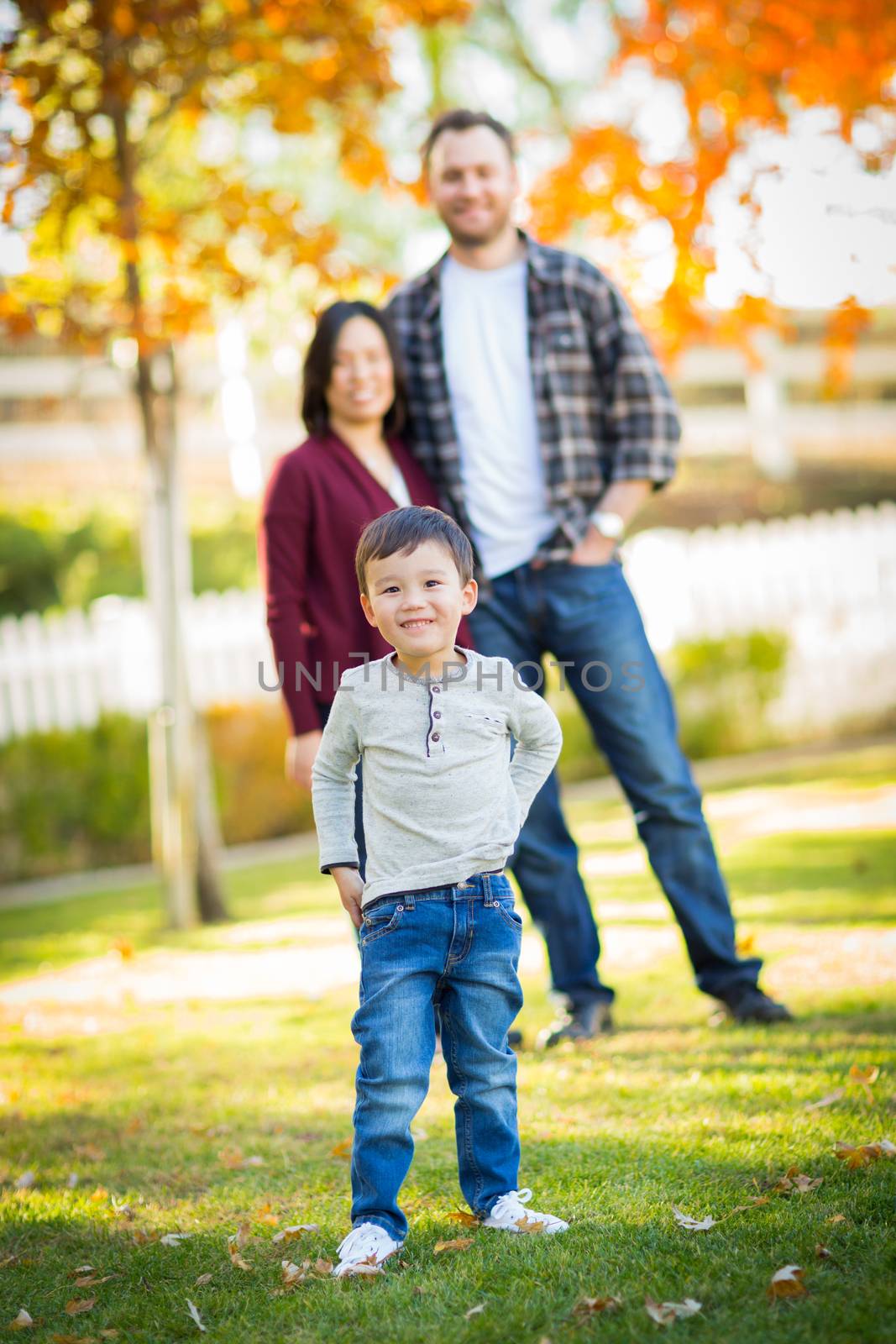 Outdoor Portrait of Happy Mixed Race Chinese and Caucasian Parents and Child. by Feverpitched