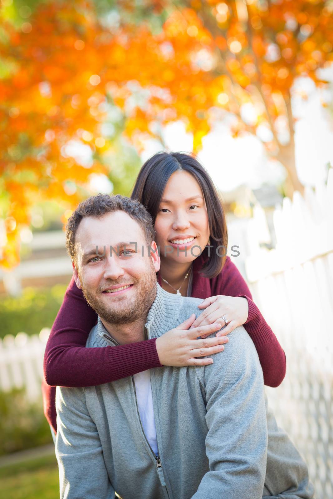 Outdoor Fall Portrait of Chinese and Caucasian Young Adult Couple.