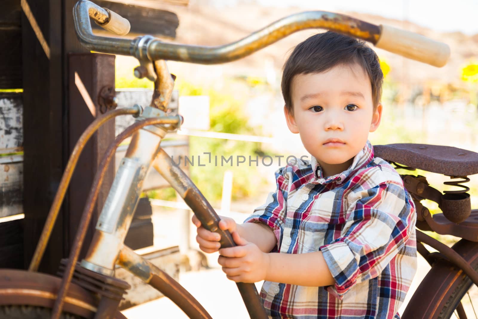 Mixed Race Caucasian and Chinese Young Boy Having Fun on the Bicycle.