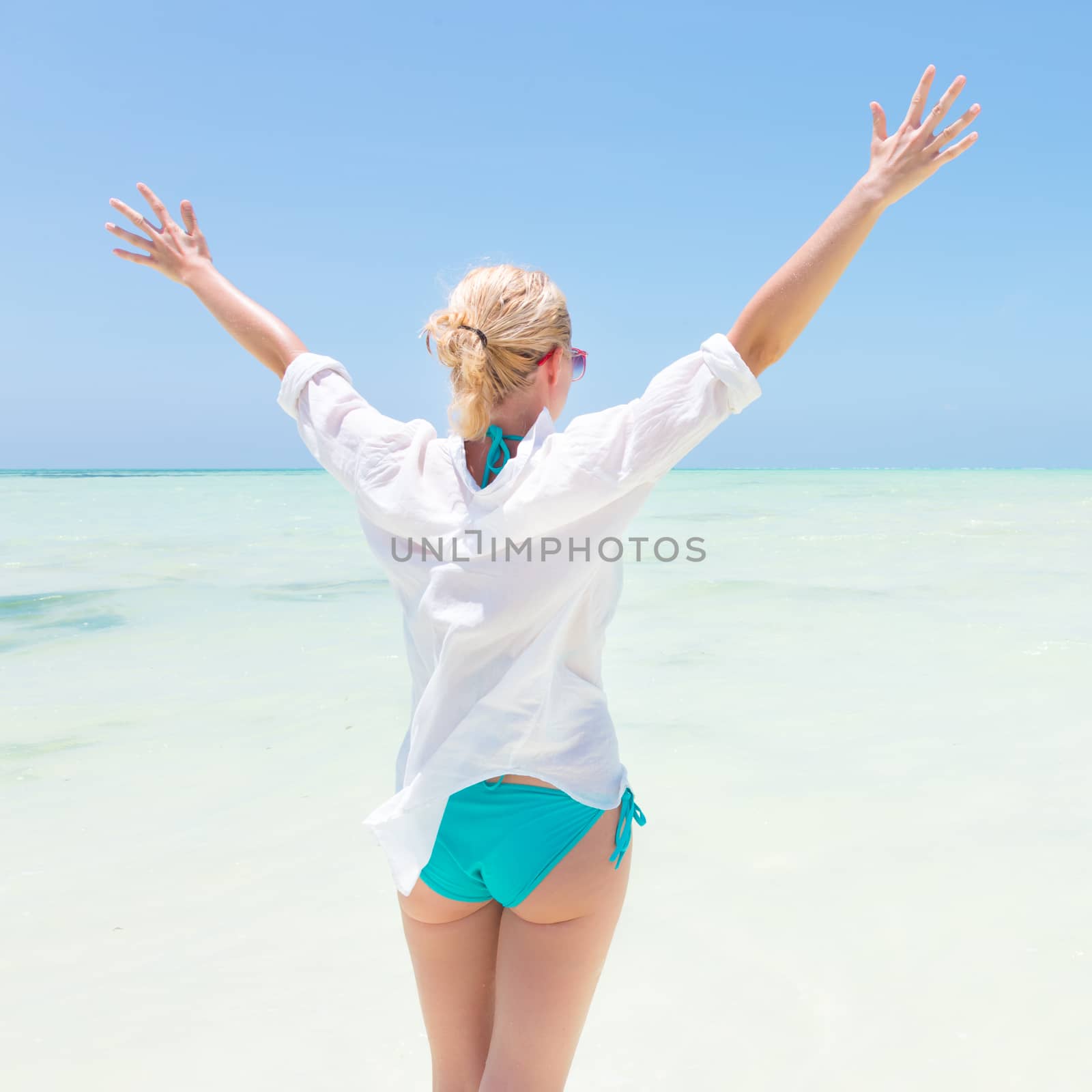 Happy woman enjoying, relaxing joyfully in summer on tropical beach. by kasto
