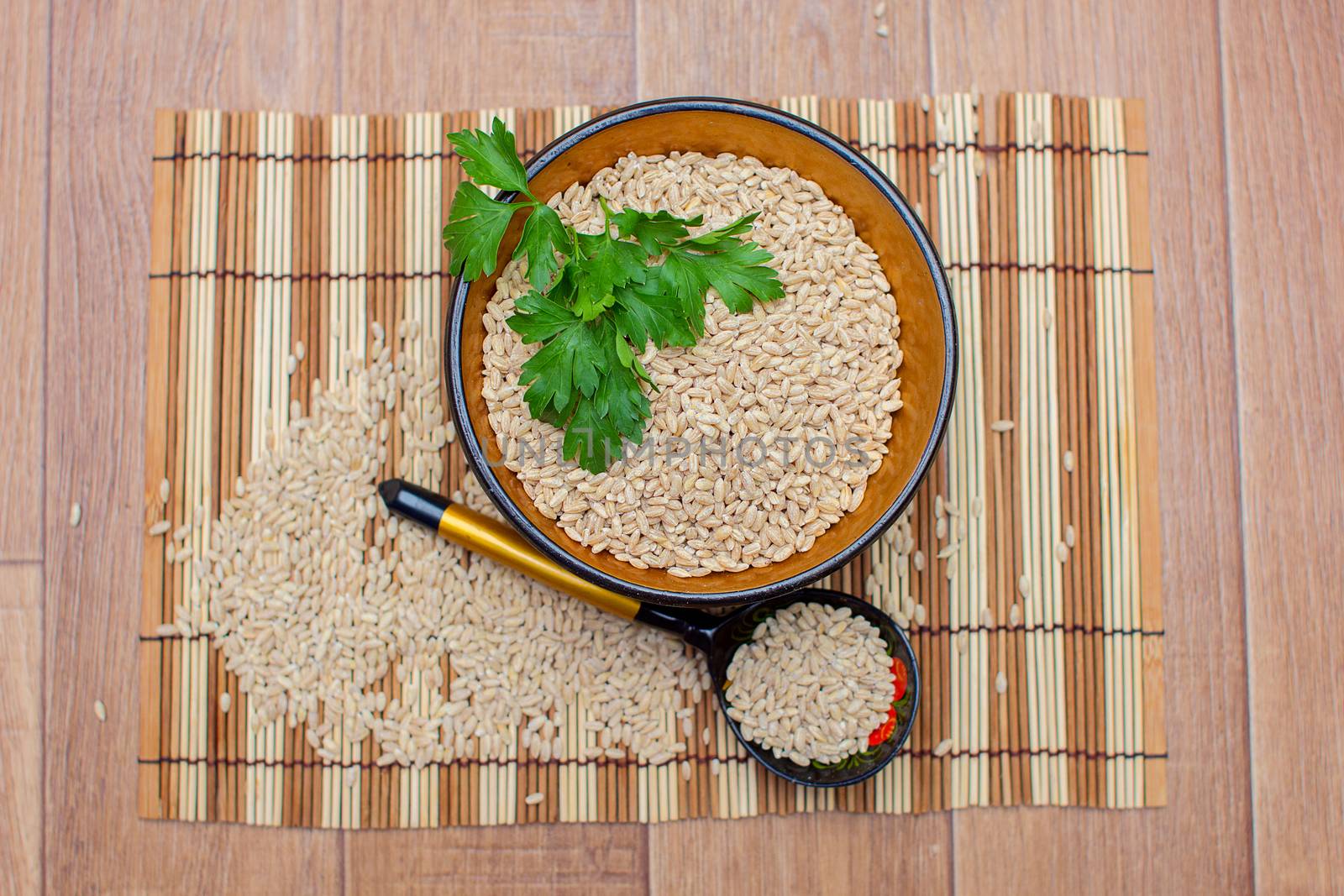 The wooden plate with pearl barley decorated with parsley, Khokhloma