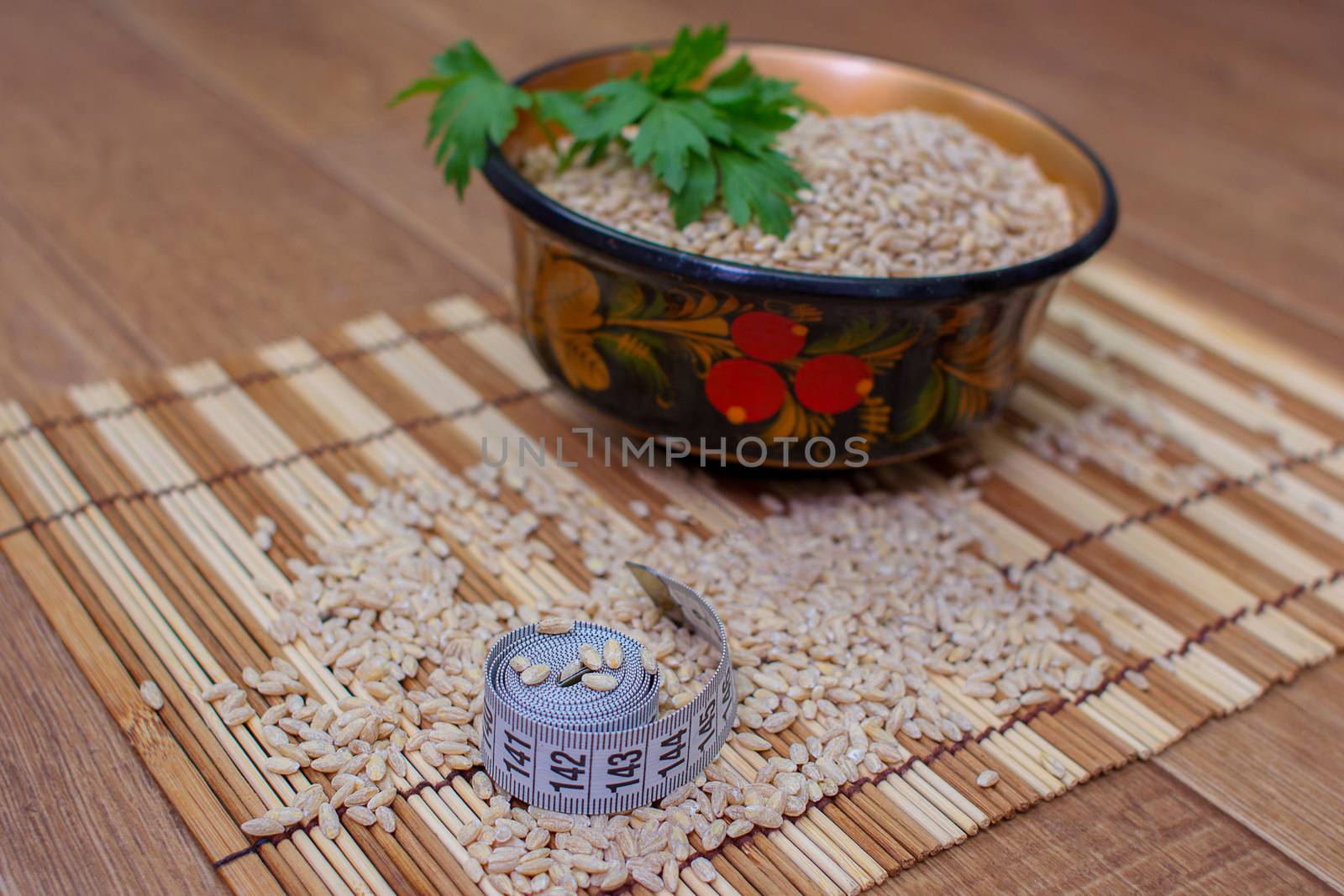 Wooden ware of folk art with pearl barley and centimeter, the Russian Khokhloma