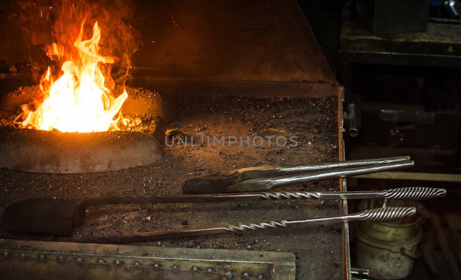 Blacksmith at work, hit with a hammer by a hot metal on the anvil.