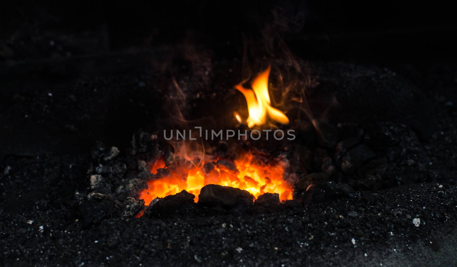 Blacksmith at work, hit with a hammer by a hot metal on the anvil.