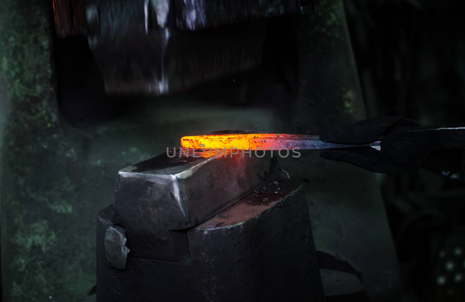 Blacksmith at work, hit with a hammer by a hot metal on the anvil.