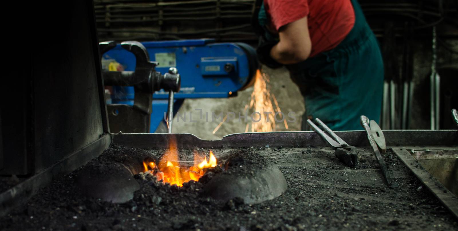 Blacksmith at work, hit with a hammer by a hot metal on the anvil.