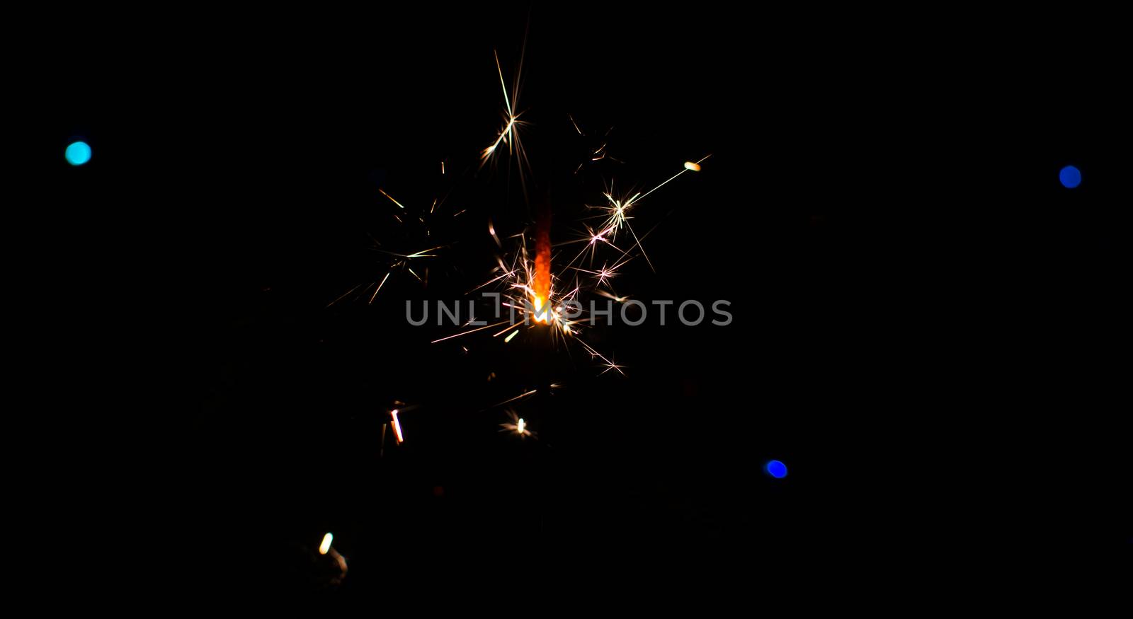 Sparkler and Christmas lights as an ideal background