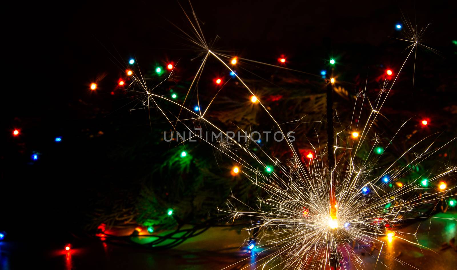 Sparkler and Christmas lights as an ideal background