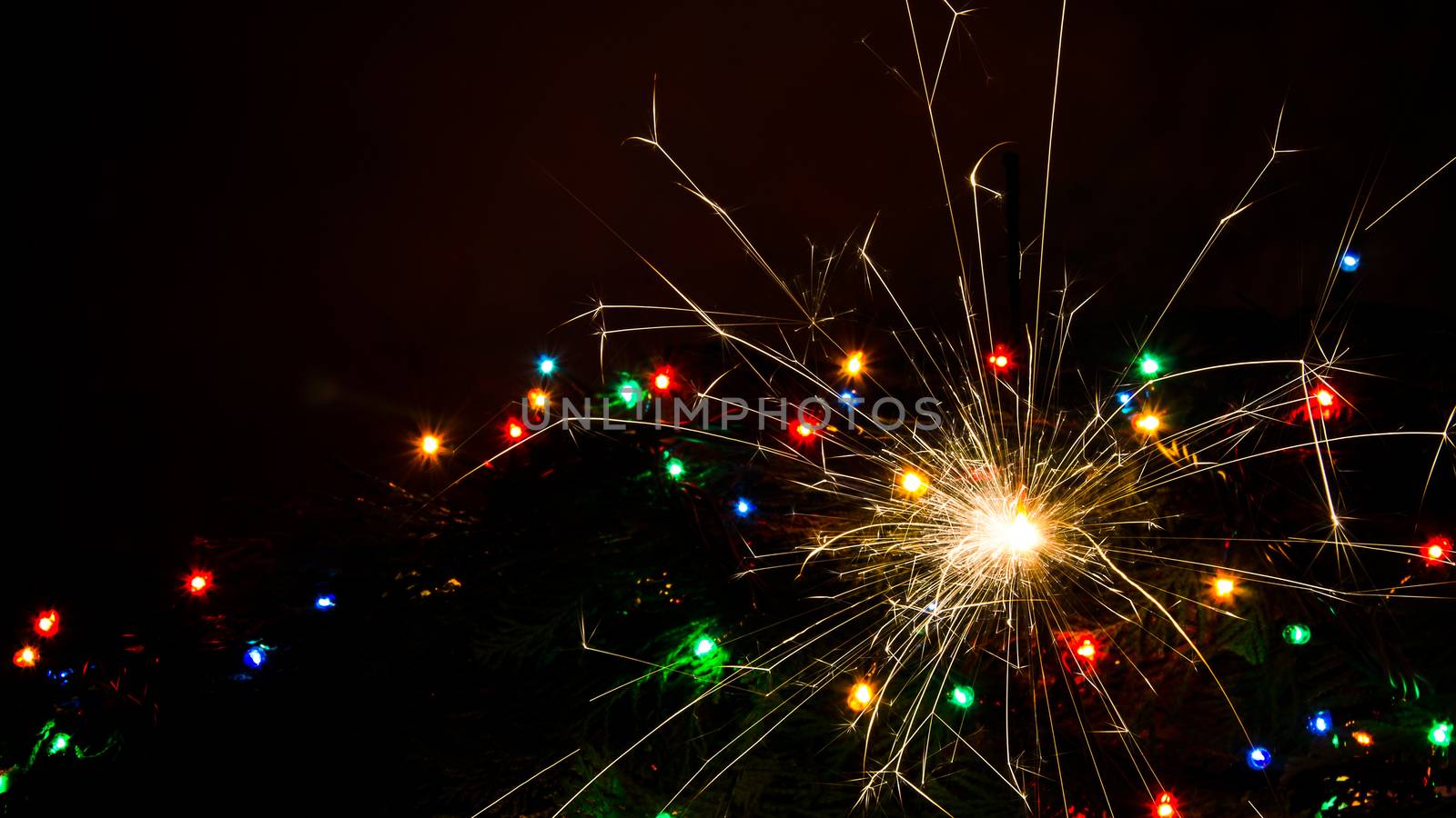 Sparkler and Christmas lights as an ideal background