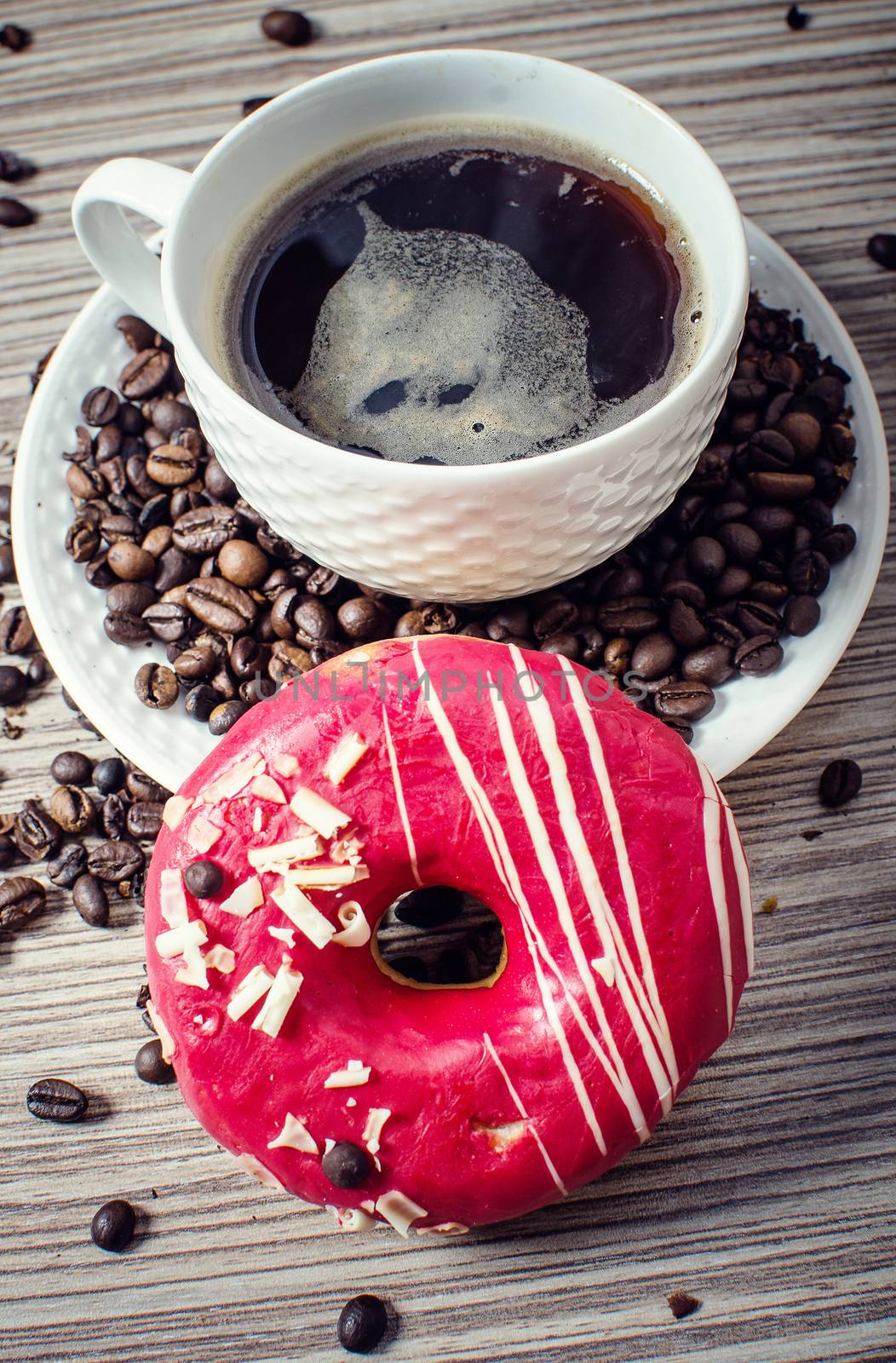 A chocolate donut with coffee for a hearty breakfast.