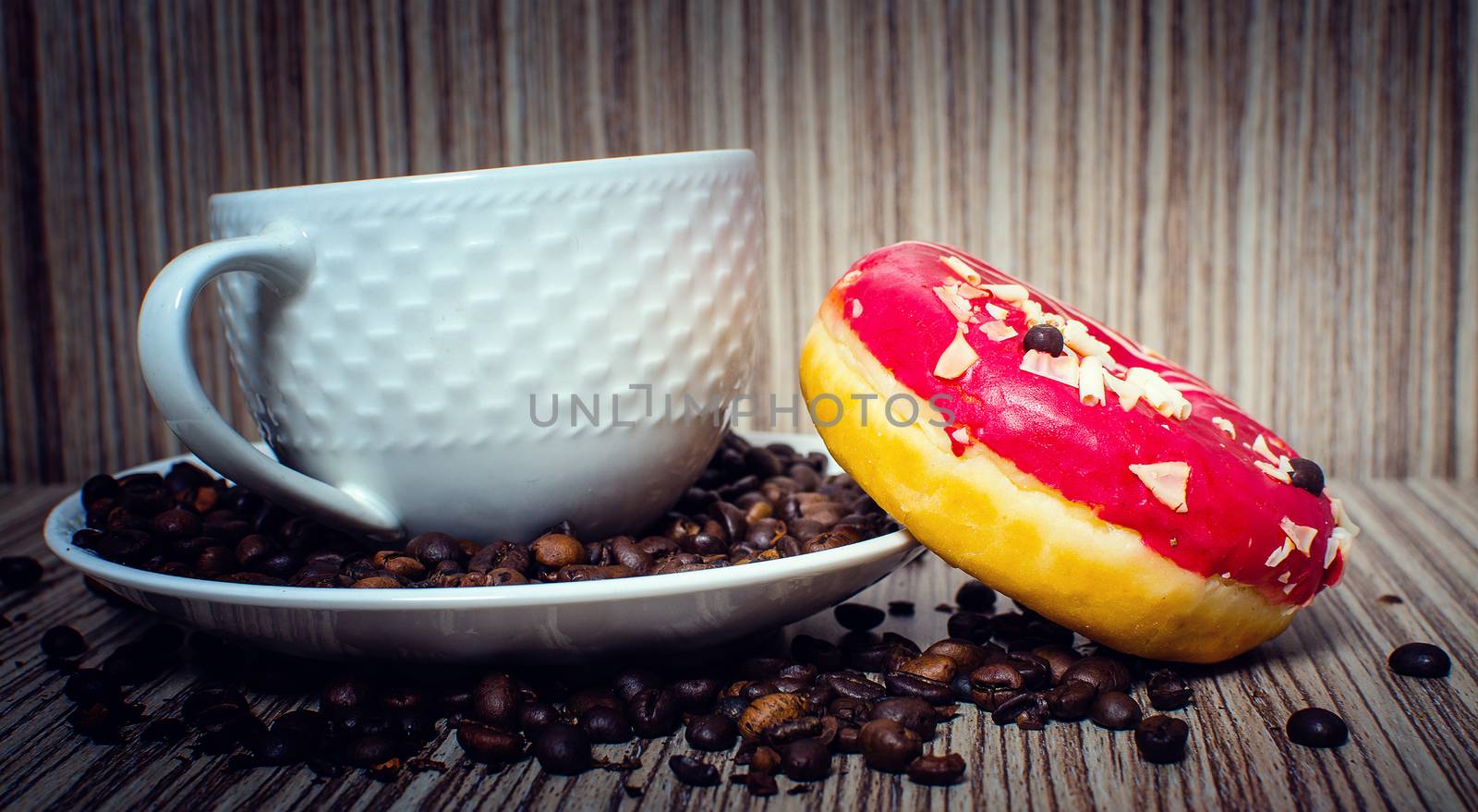 A chocolate donut with coffee for a hearty breakfast.