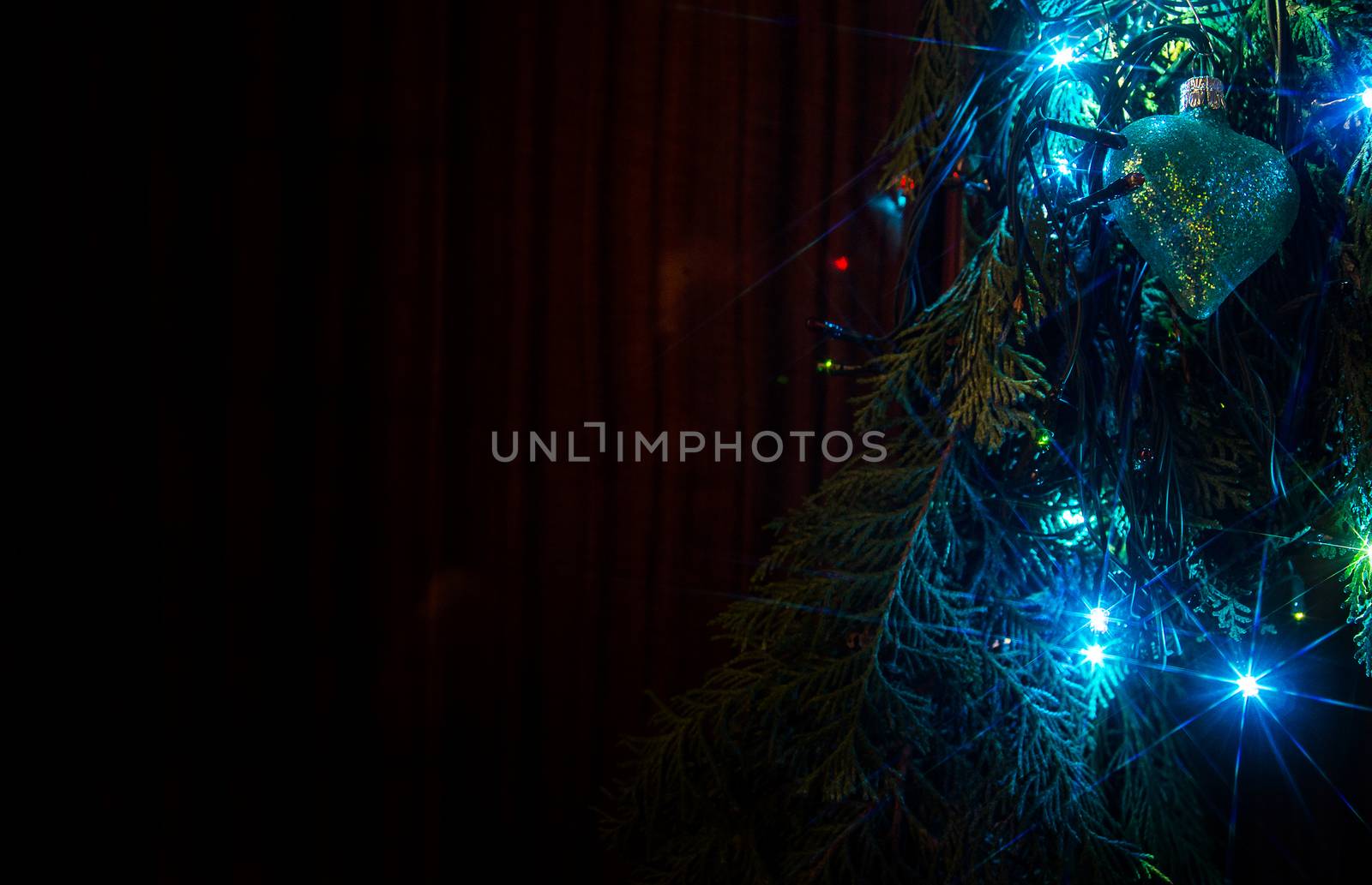 Christmas lights on a tree in different colors are classic symbol of Christmas.