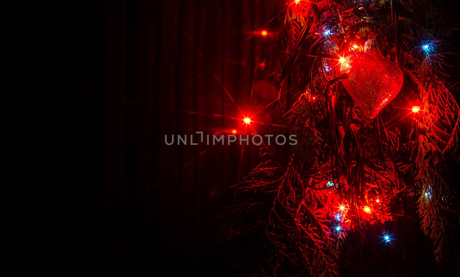 Christmas lights on a tree in different colors are classic symbol of Christmas.
