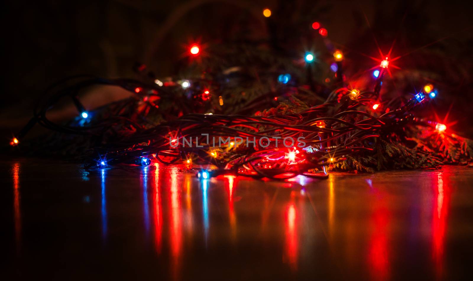 Christmas lights on a tree in different colors are classic symbol of Christmas.