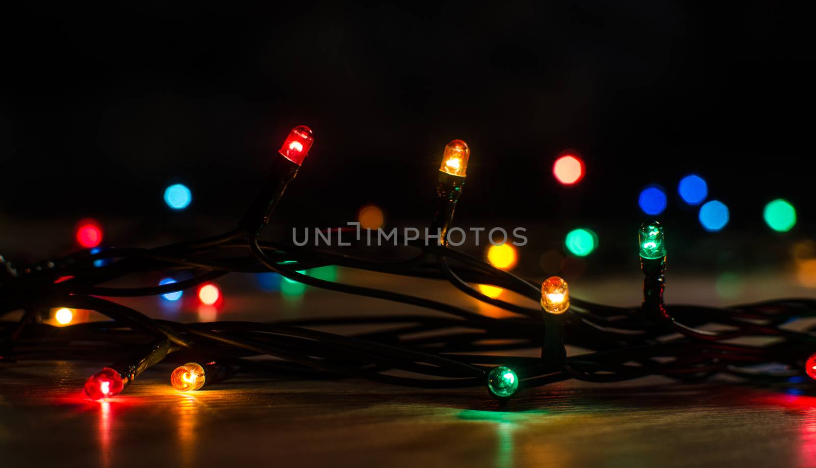 Christmas lights on a tree in different colors are classic symbol of Christmas.