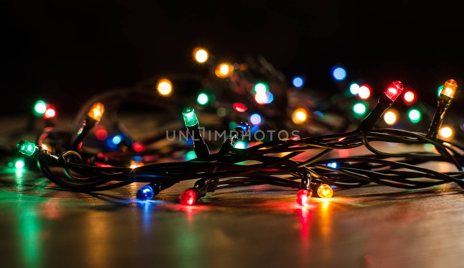 Christmas lights on a tree in different colors are classic symbol of Christmas.