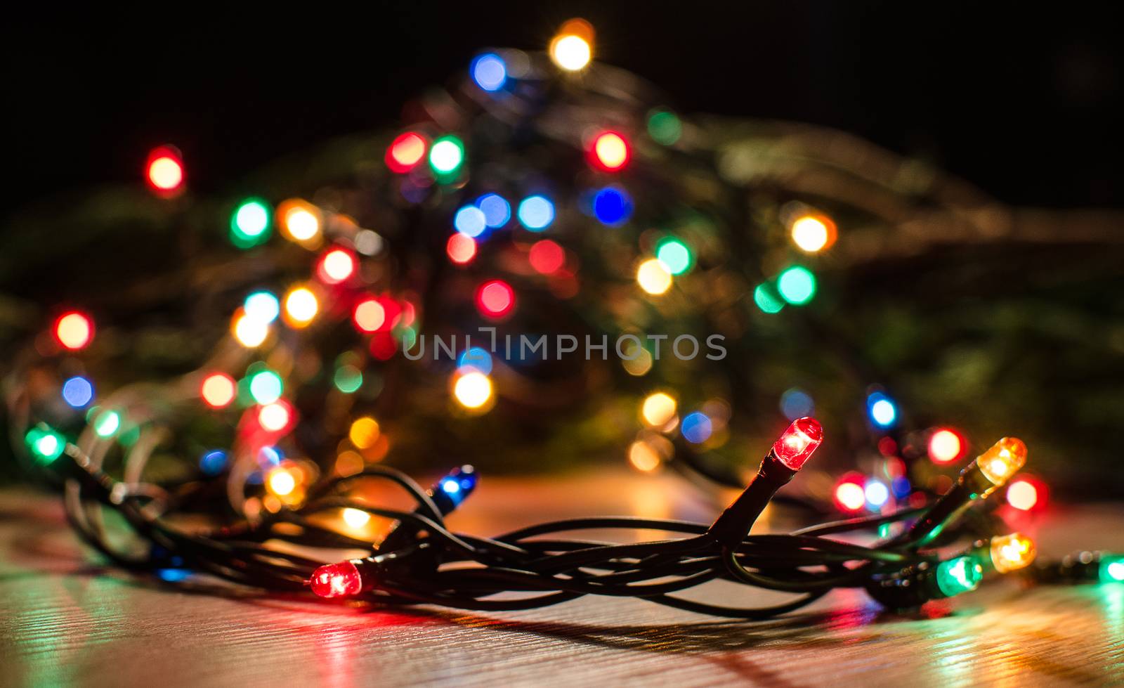 Christmas lights on a tree in different colors are classic symbol of Christmas.