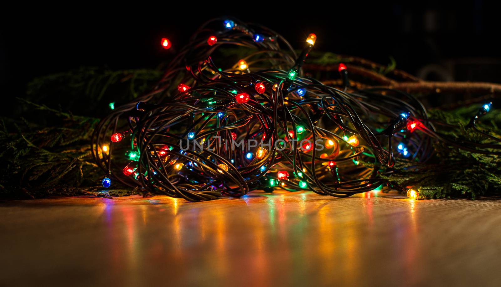 Christmas lights on a tree in different colors are classic symbol of Christmas.