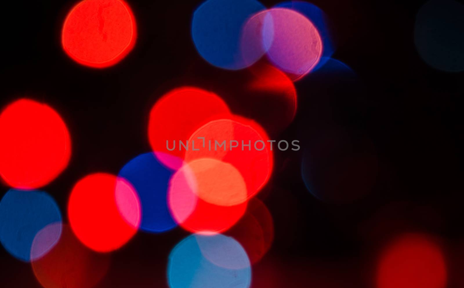 Deliberately blurred Christmas color lights in the background.