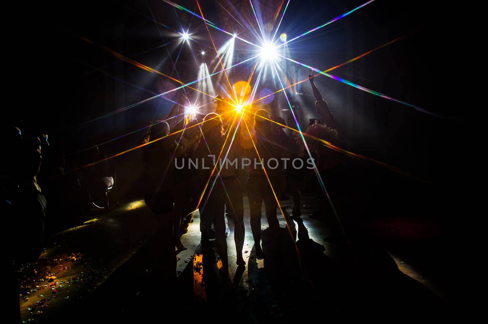 Young dancing people at the party in the shadow.