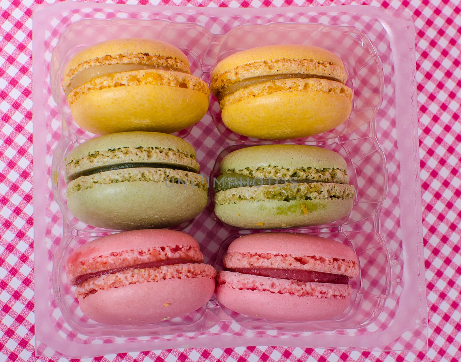 Colorful sweet macaroons on retro background.