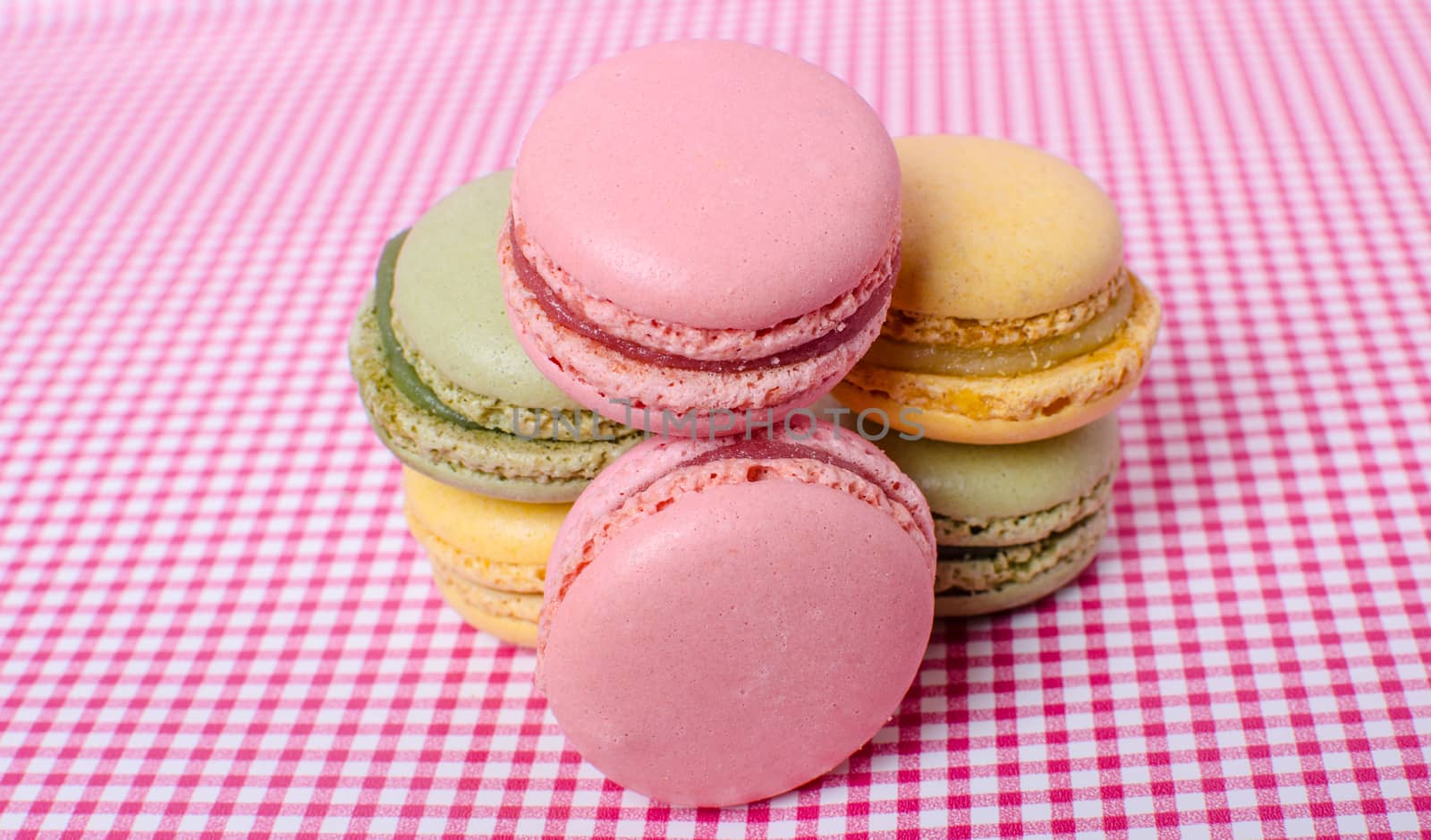 Colorful sweet macaroons on retro background.