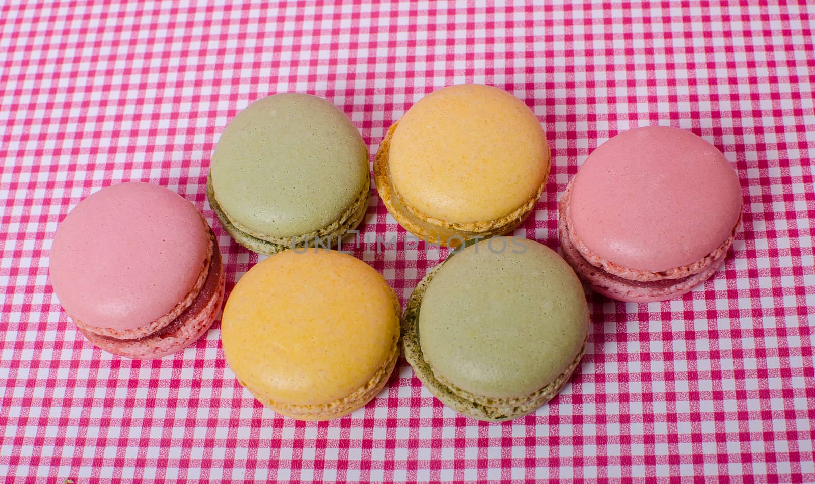 Colorful sweet macaroons on retro background.