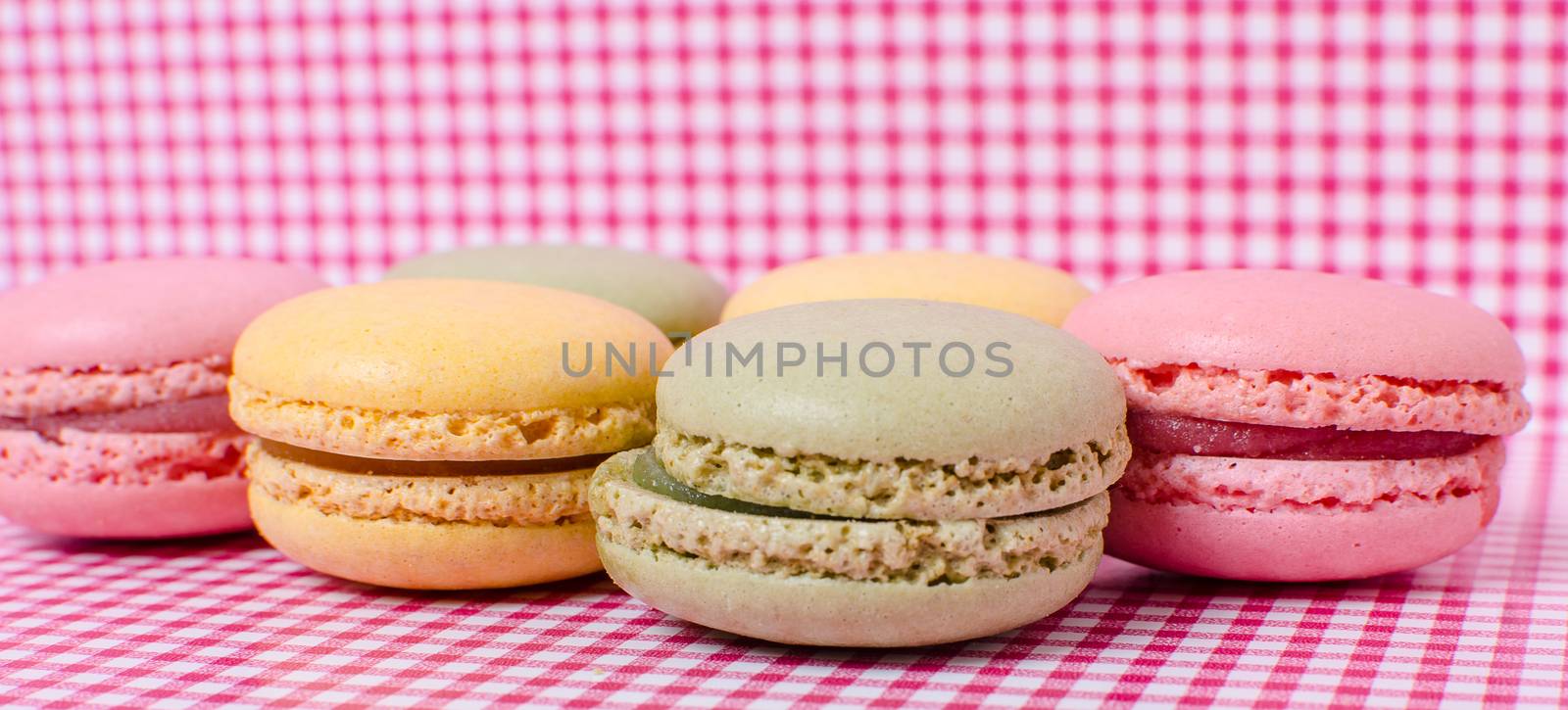 Colorful sweet macaroons on retro background.