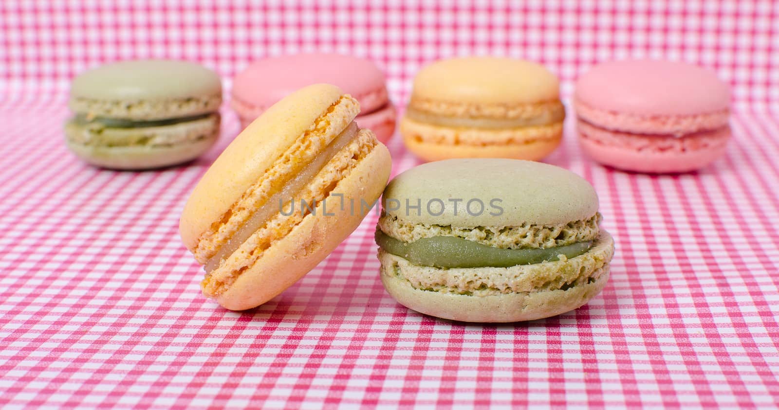 Colorful sweet macaroons on retro background.