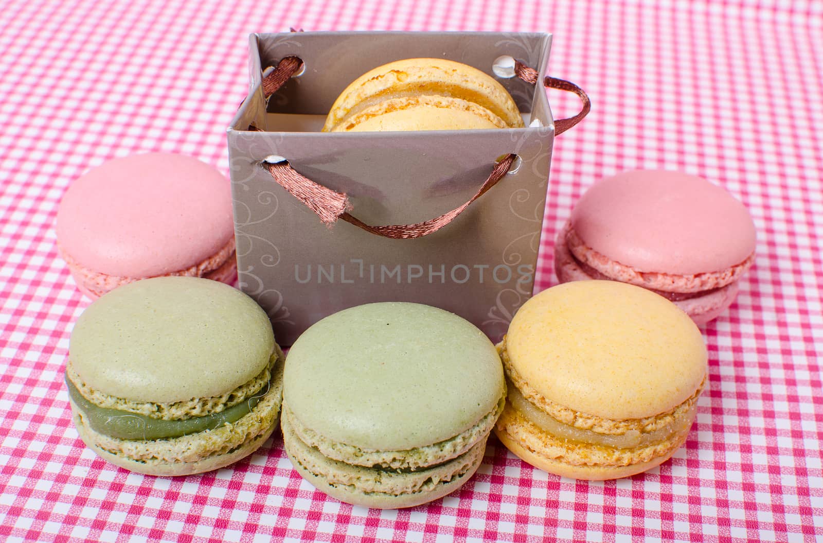 Colorful sweet macaroons on retro background.