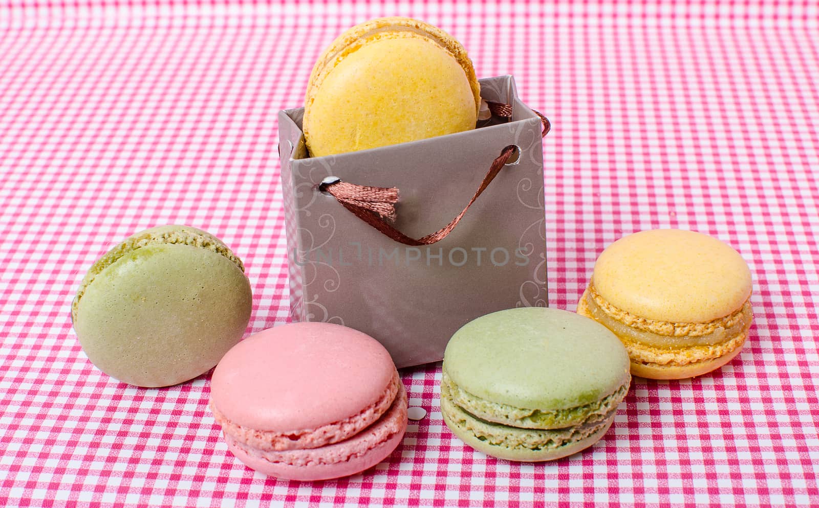 Colorful sweet macaroons on retro background.