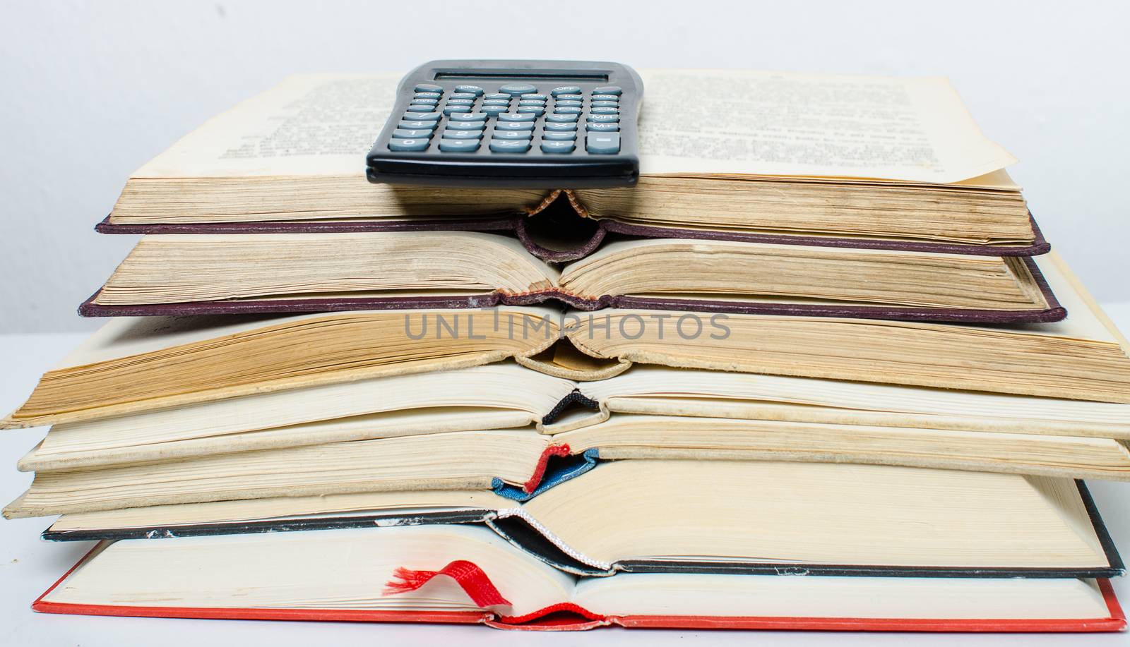 A  pile of books and a calculator help in learning.