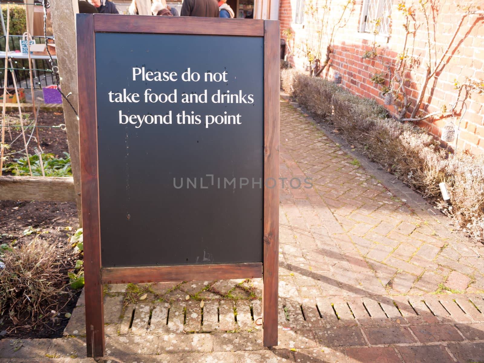 outside area restriction sign cafe - please do not take food and drinks beyond this point black and wood chalkboard; essex; england; uk
