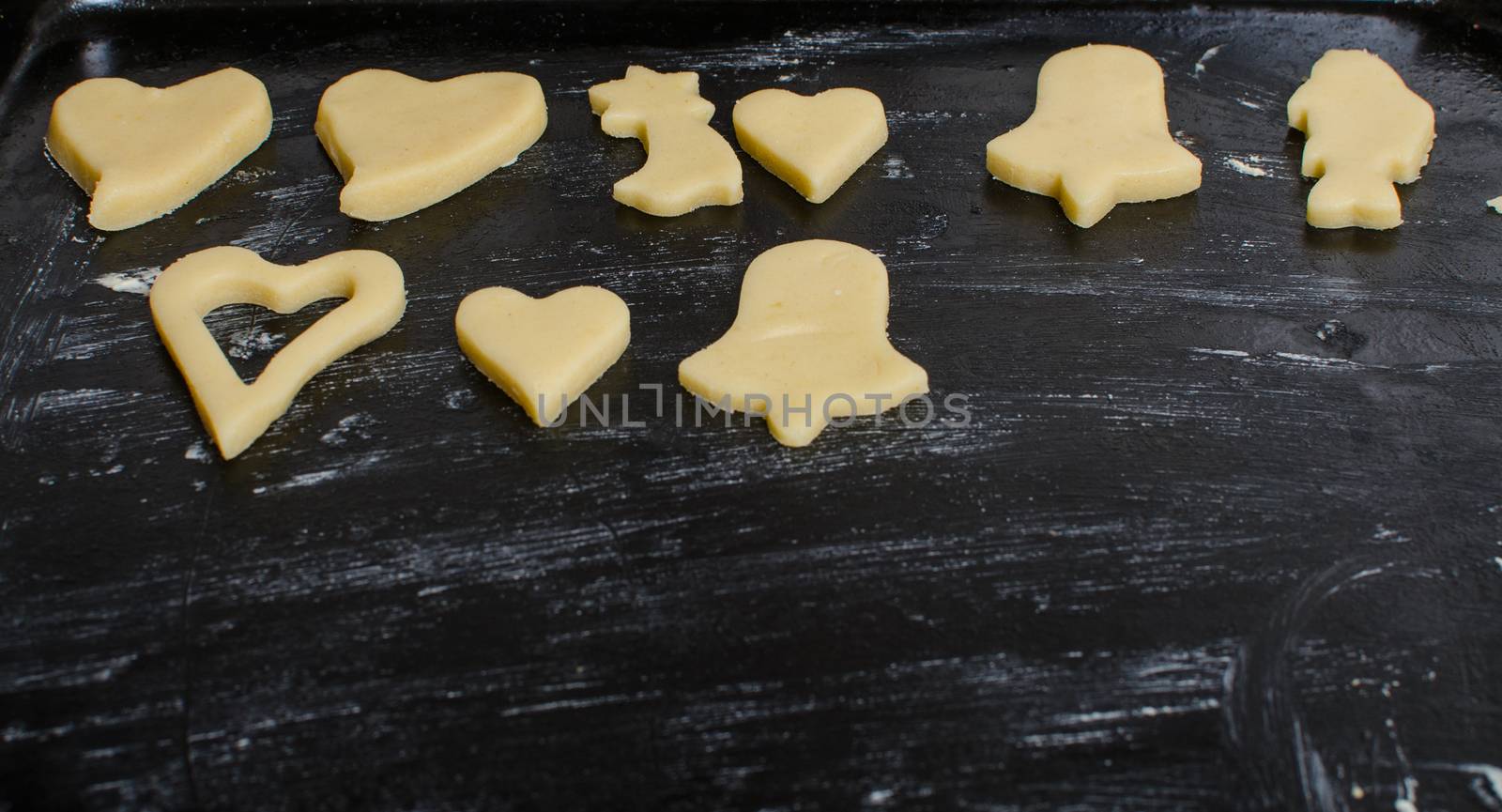 Cutting and baking Christmas cookies in Advent Time.