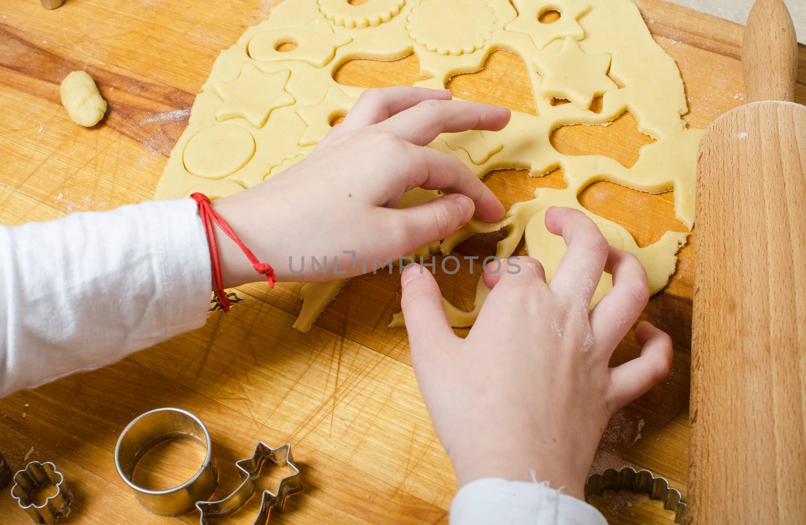 Cutting and baking Christmas cookies in Advent Time.