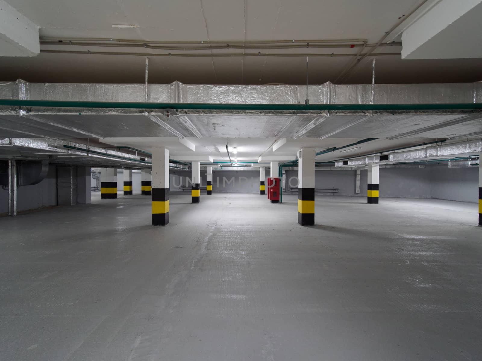 Empty underground parking in new building under construction