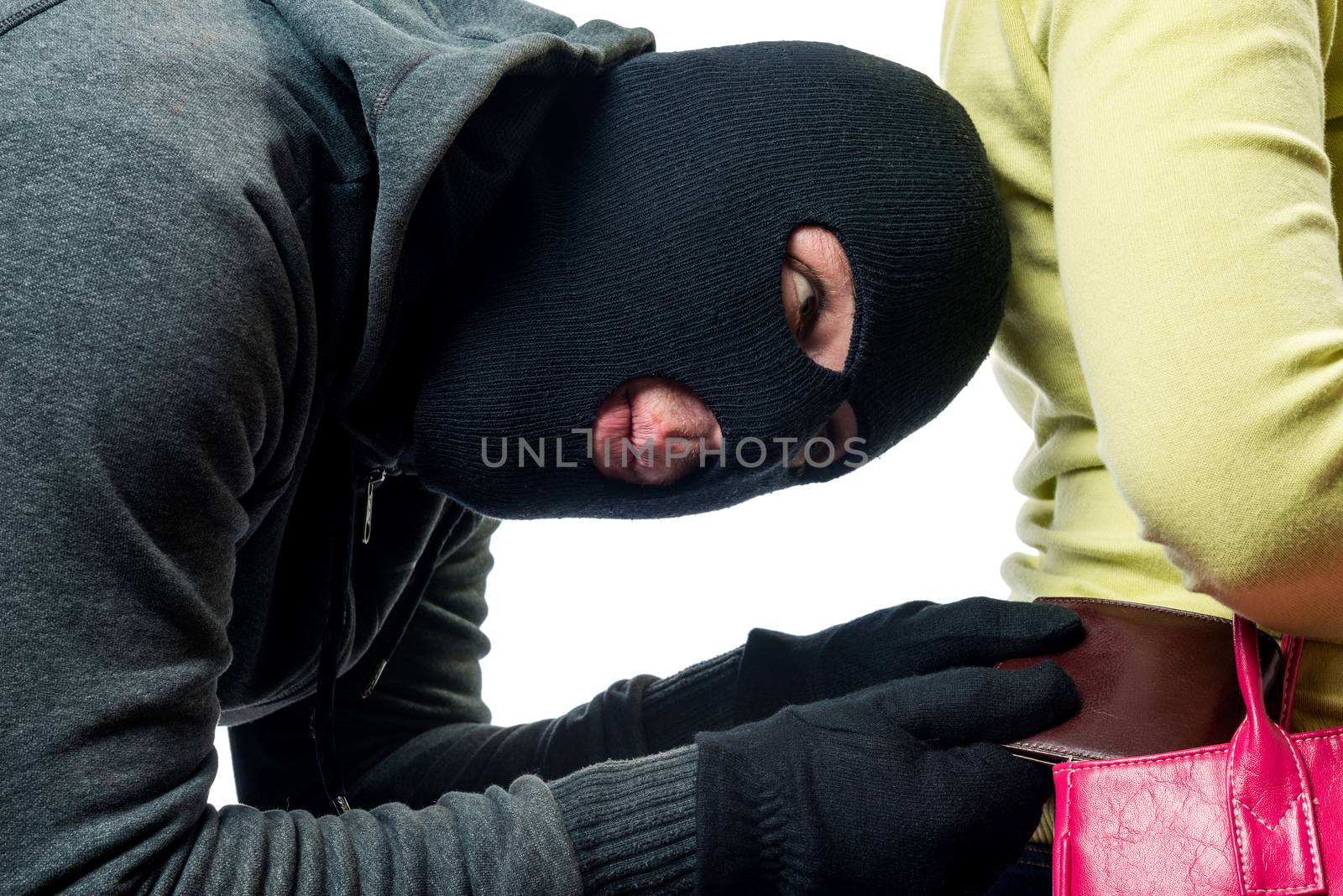 Close-up of a thief pickpocket while stealing a purse from a bag