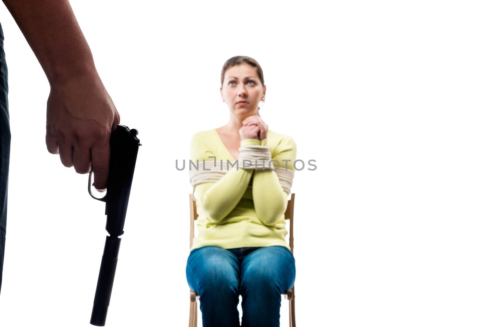 Close-up of a terrorist hand with arms and an innocent hostage victim on a white background
