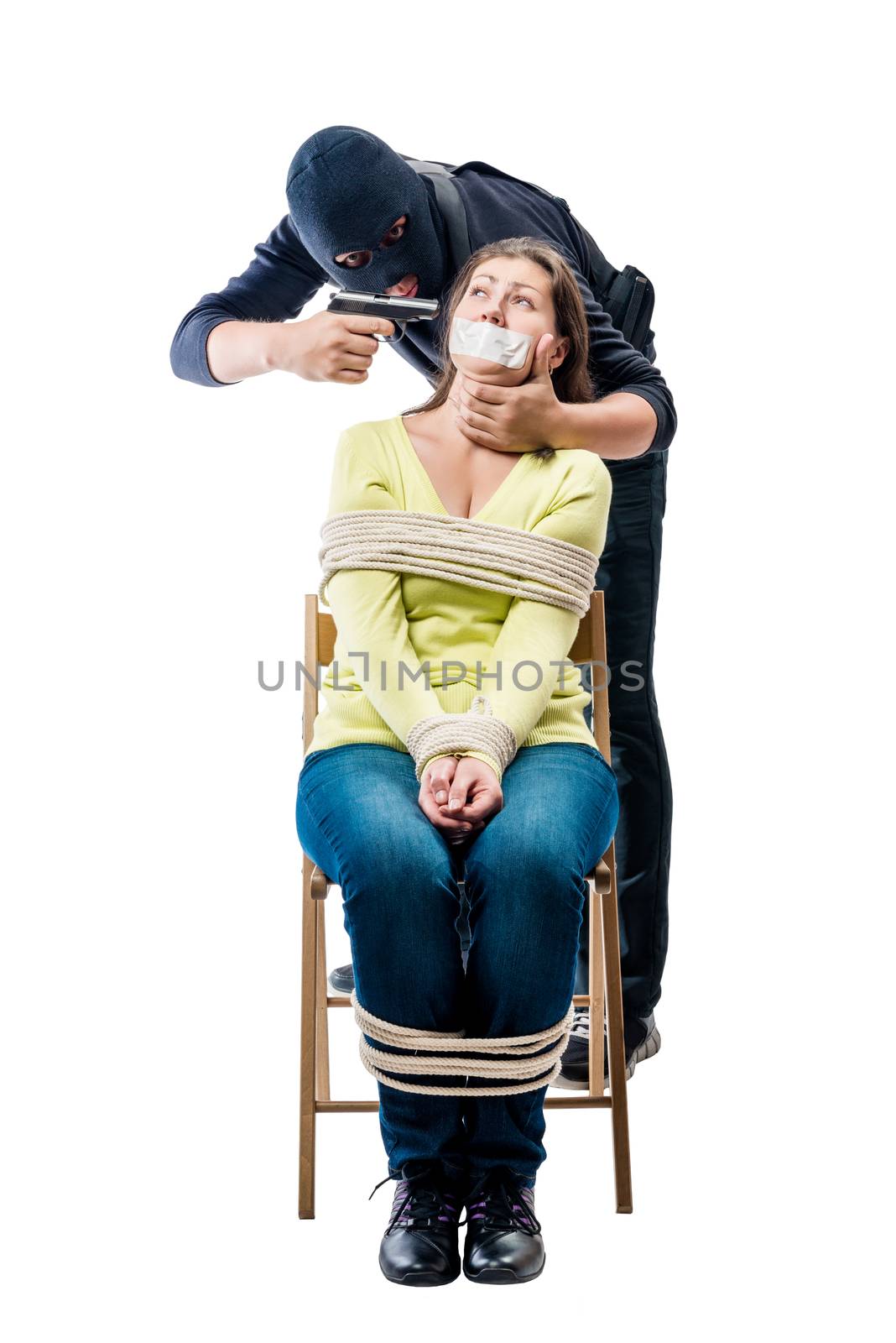 Cruel criminal in a balaclava with arms and girl hostage on a white background