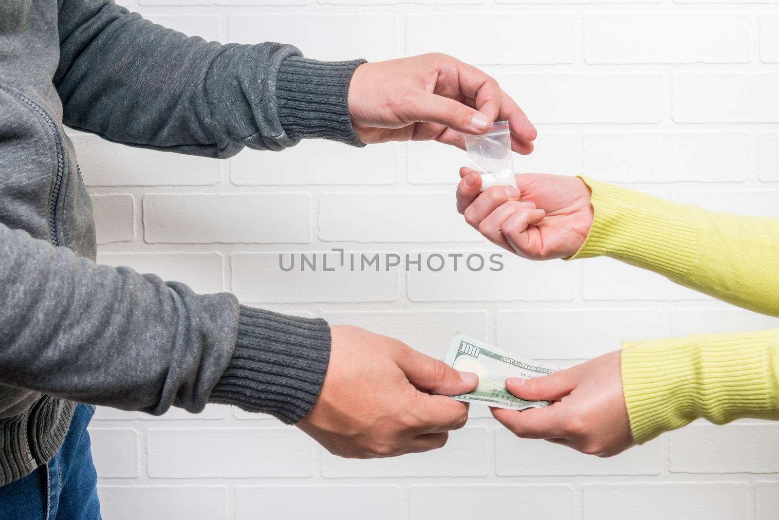 Woman drug addict buys drugs from a man, hands close-up