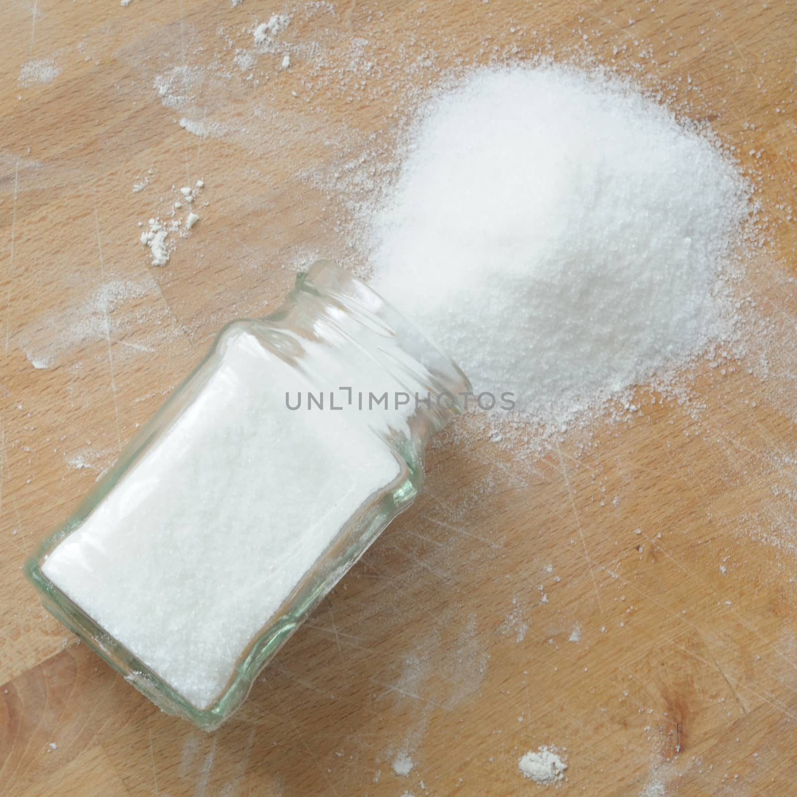 top view of overturned sugar on kitchen table, square