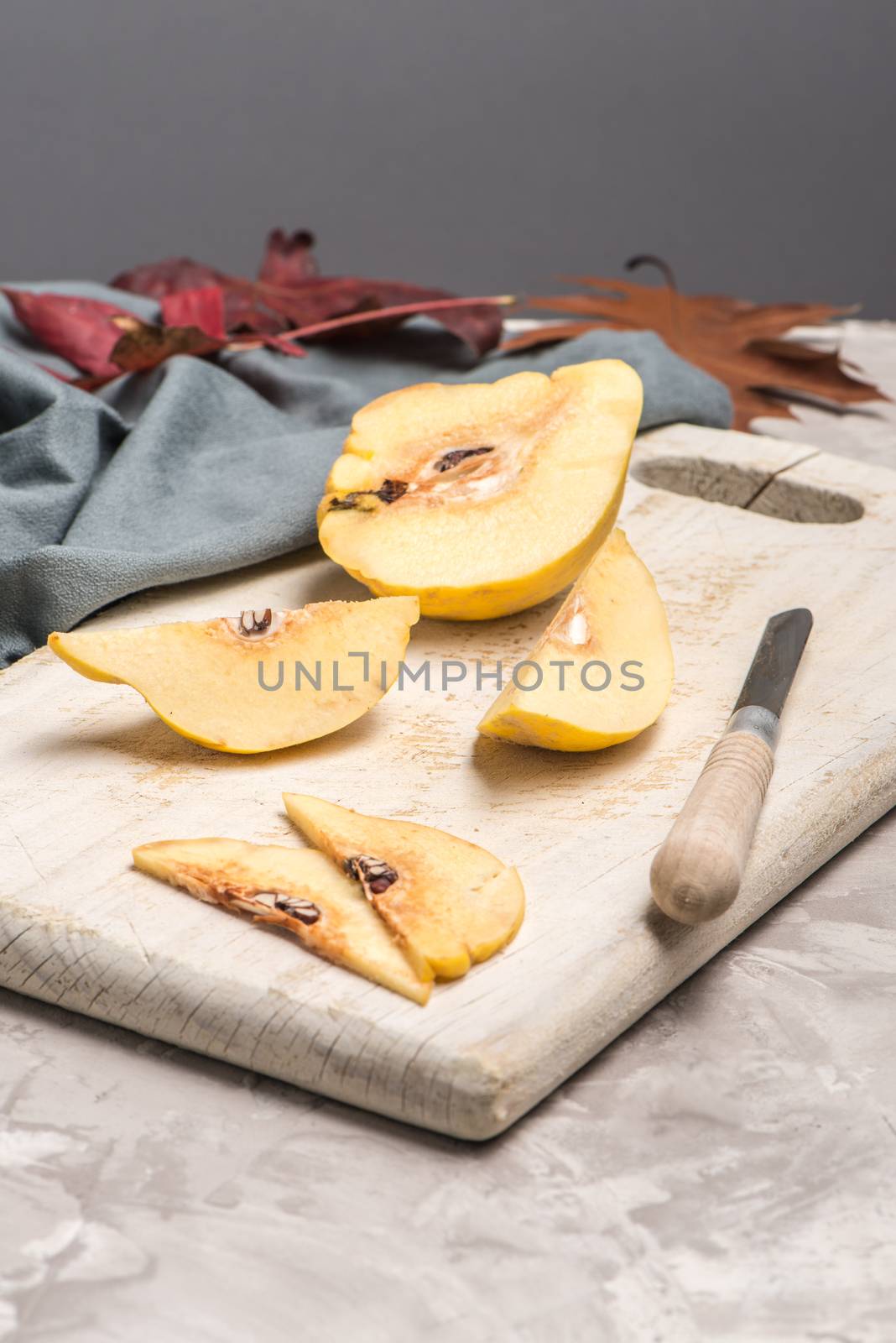 Quince fruit parts on concrete kitchen countertop.