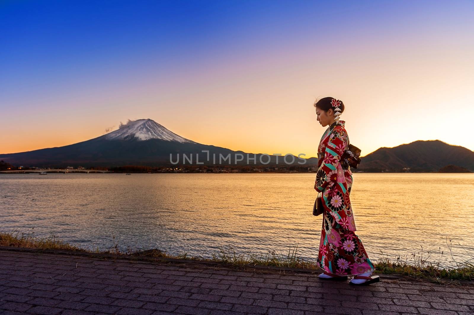 Asian woman wearing japanese traditional kimono at Fuji mountain. Sunset at Kawaguchiko lake in Japan. by gutarphotoghaphy