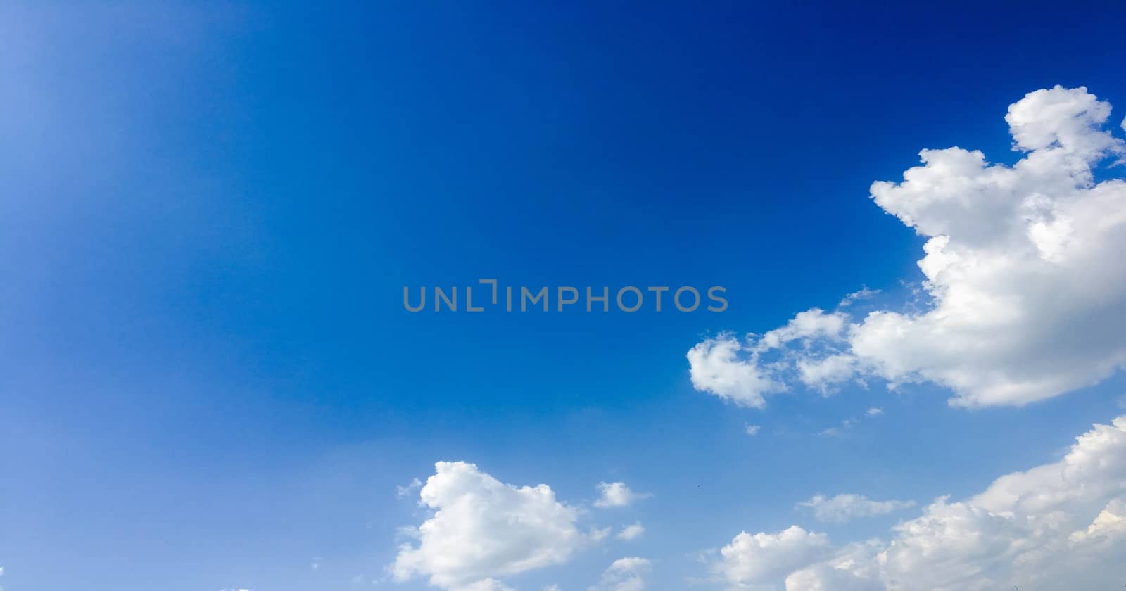 Beautiful blue sky with clouds background. Sky with clouds weather nature cloud blue. Blue sky with clouds and sun. by titco