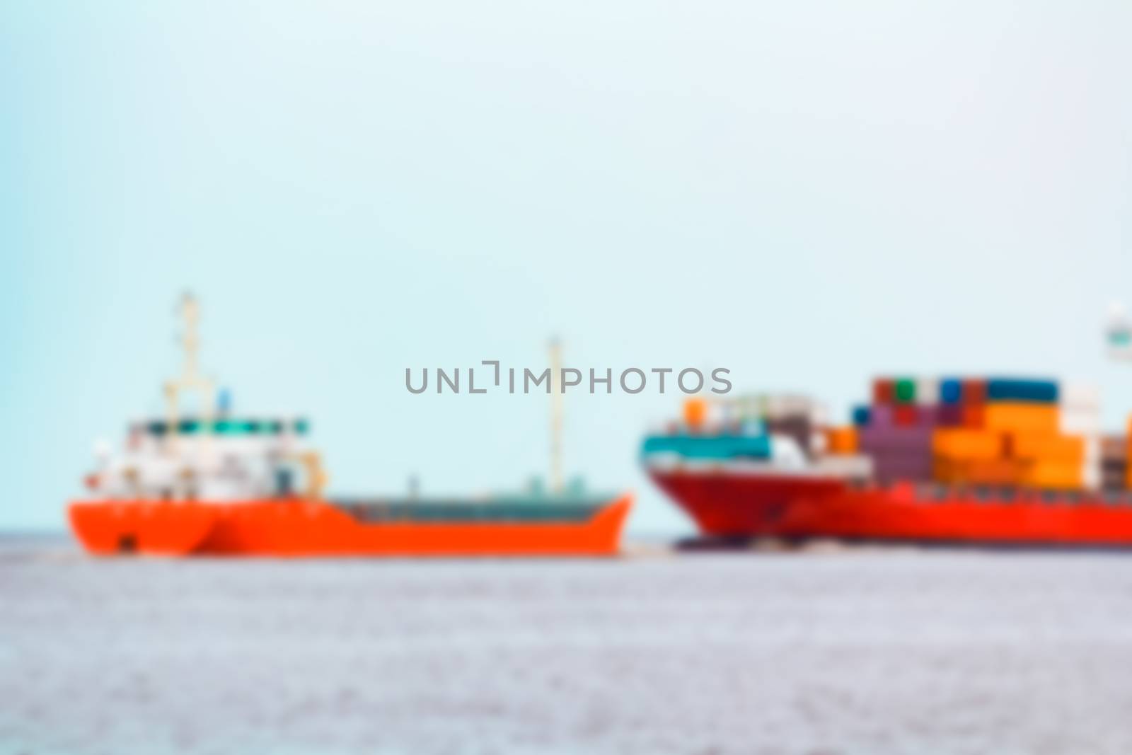 Red cargo ship - soft lens bokeh image. Defocused background