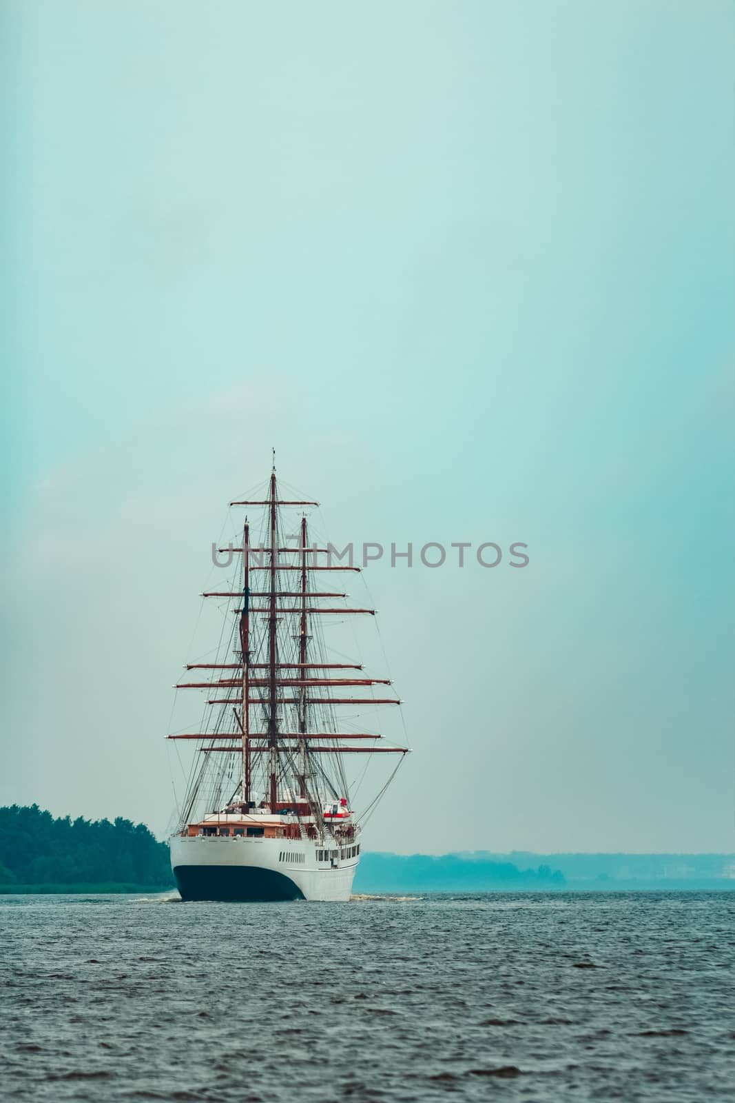 Big white sailing ship with three mast moving to the Riga port