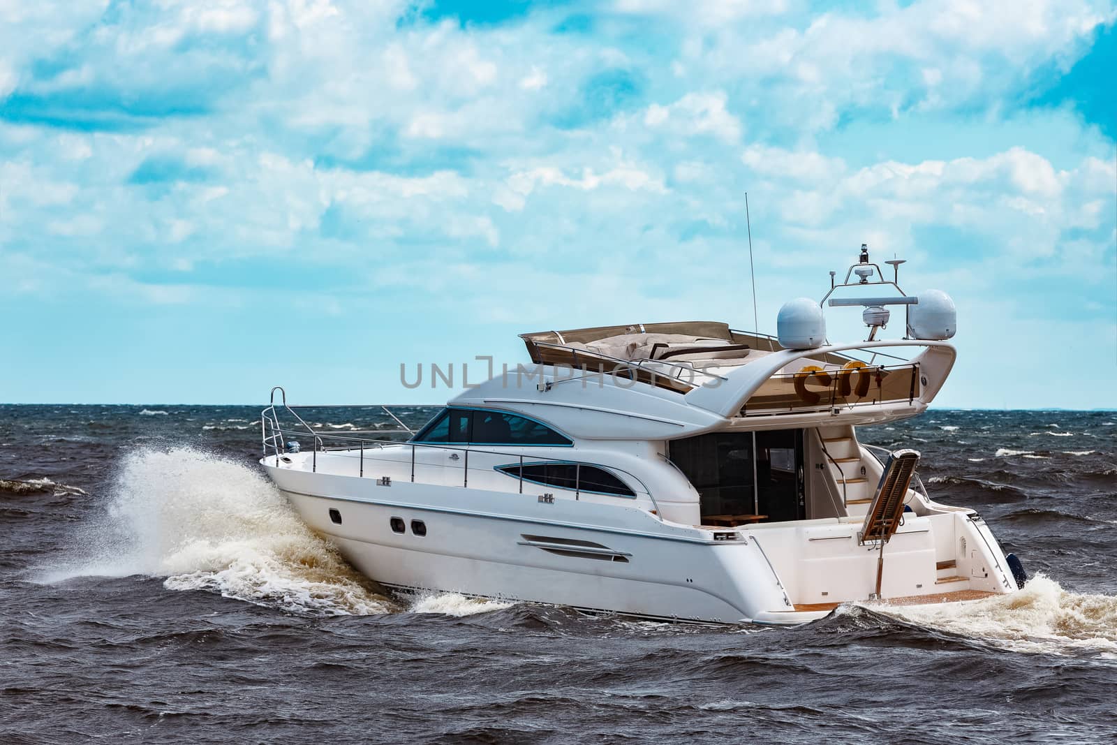 White speed boat moving fast to the Baltic sea. Water sport