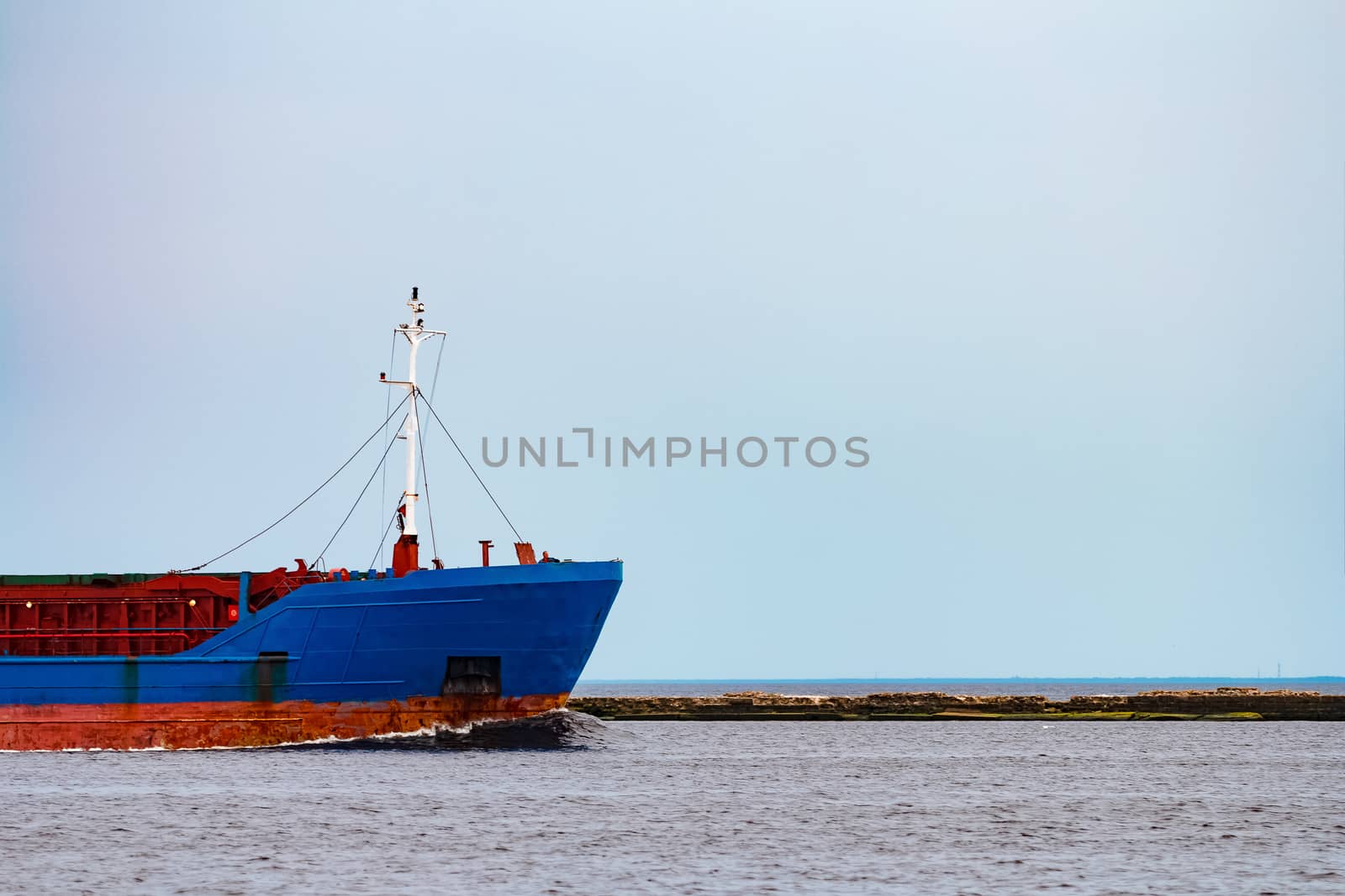 Blue cargo ship underway by sengnsp