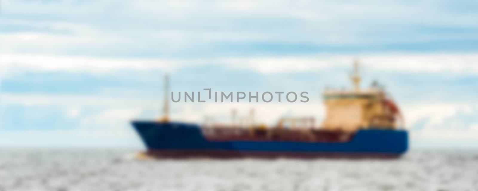 Blue cargo ship - blurred image by sengnsp