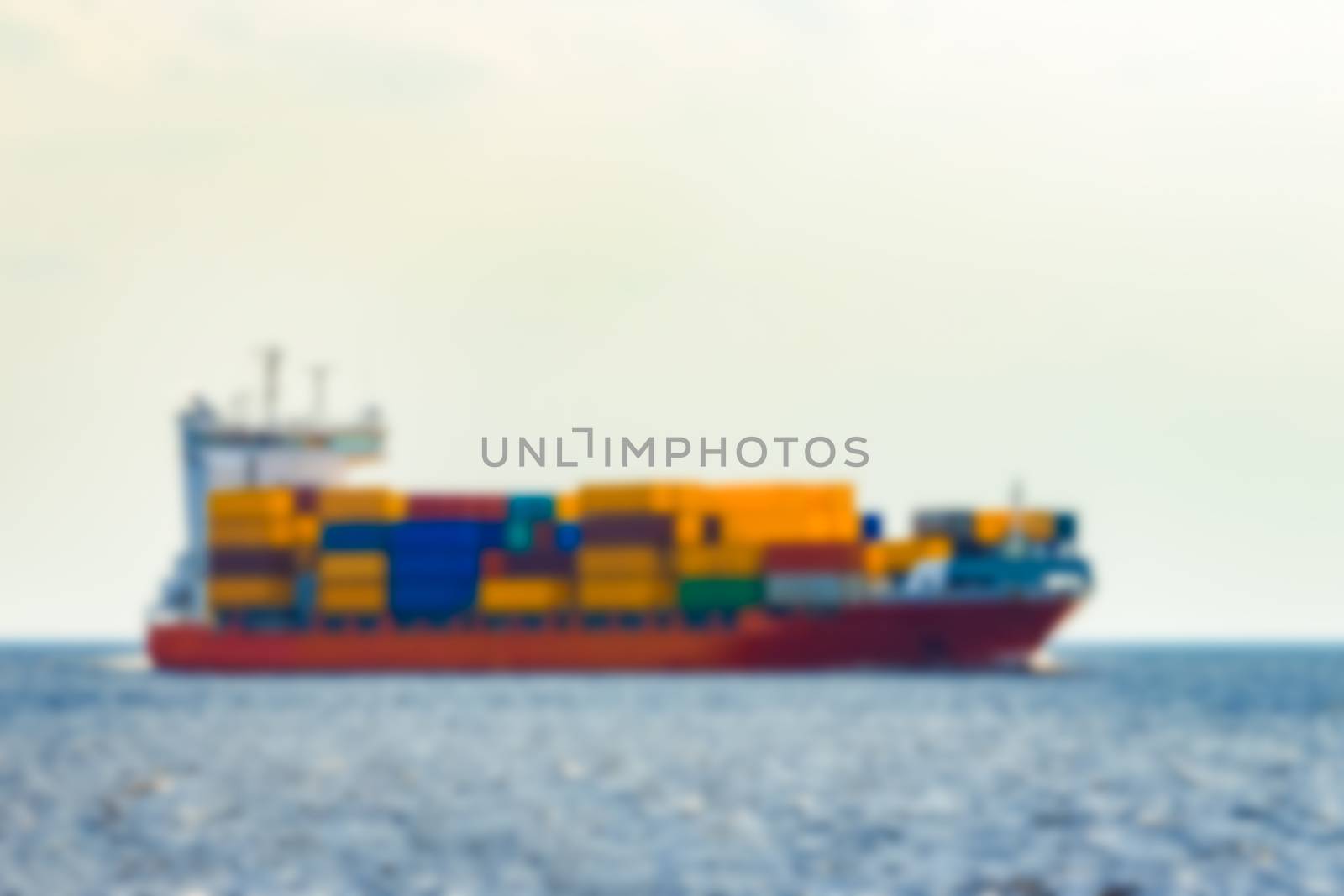 Red cargo ship - soft lens bokeh image. Defocused background